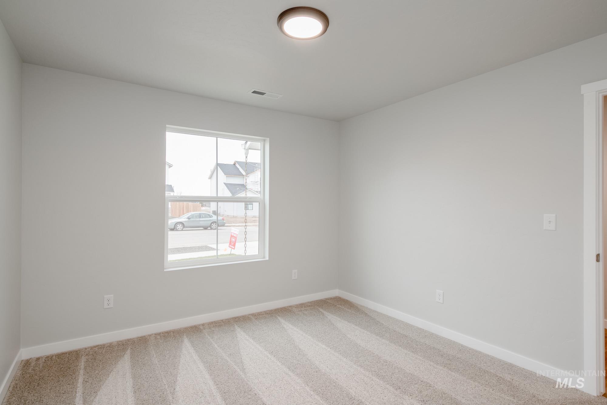 1494 Long Pond Street Middleton, ID 83644 - Photo 15 of 25 Carpeted spare room featuring baseboards