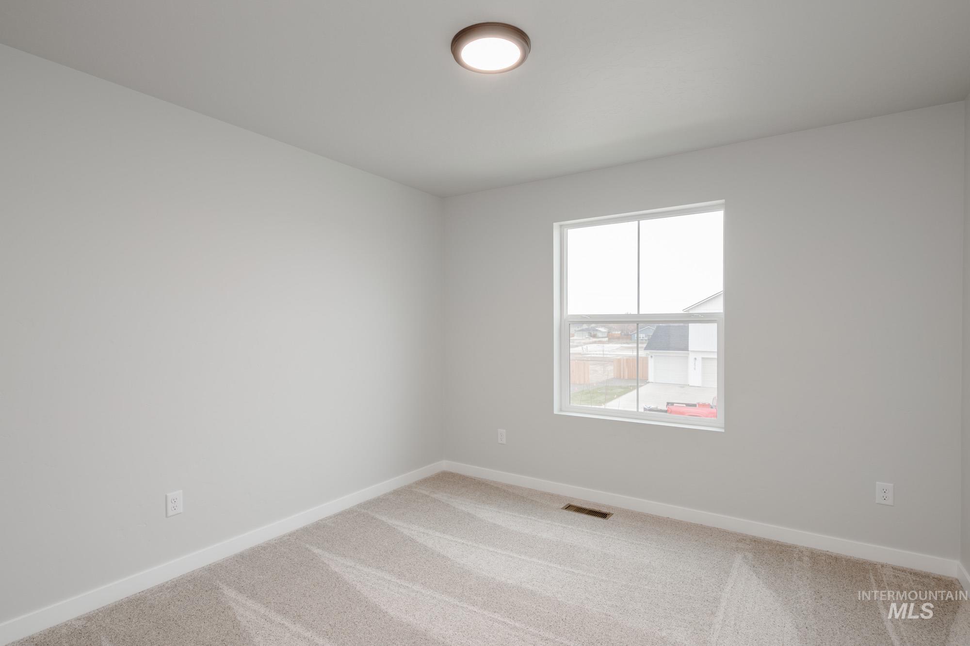 1494 Long Pond Street Middleton, ID 83644 - Photo 17 of 25 Carpeted empty room featuring baseboards