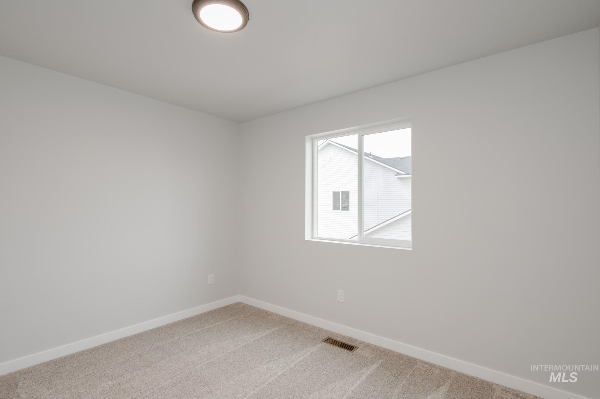 1494 Long Pond Street Middleton, ID 83644 - Photo 18 of 25 Spare room featuring baseboards and light colored carpet