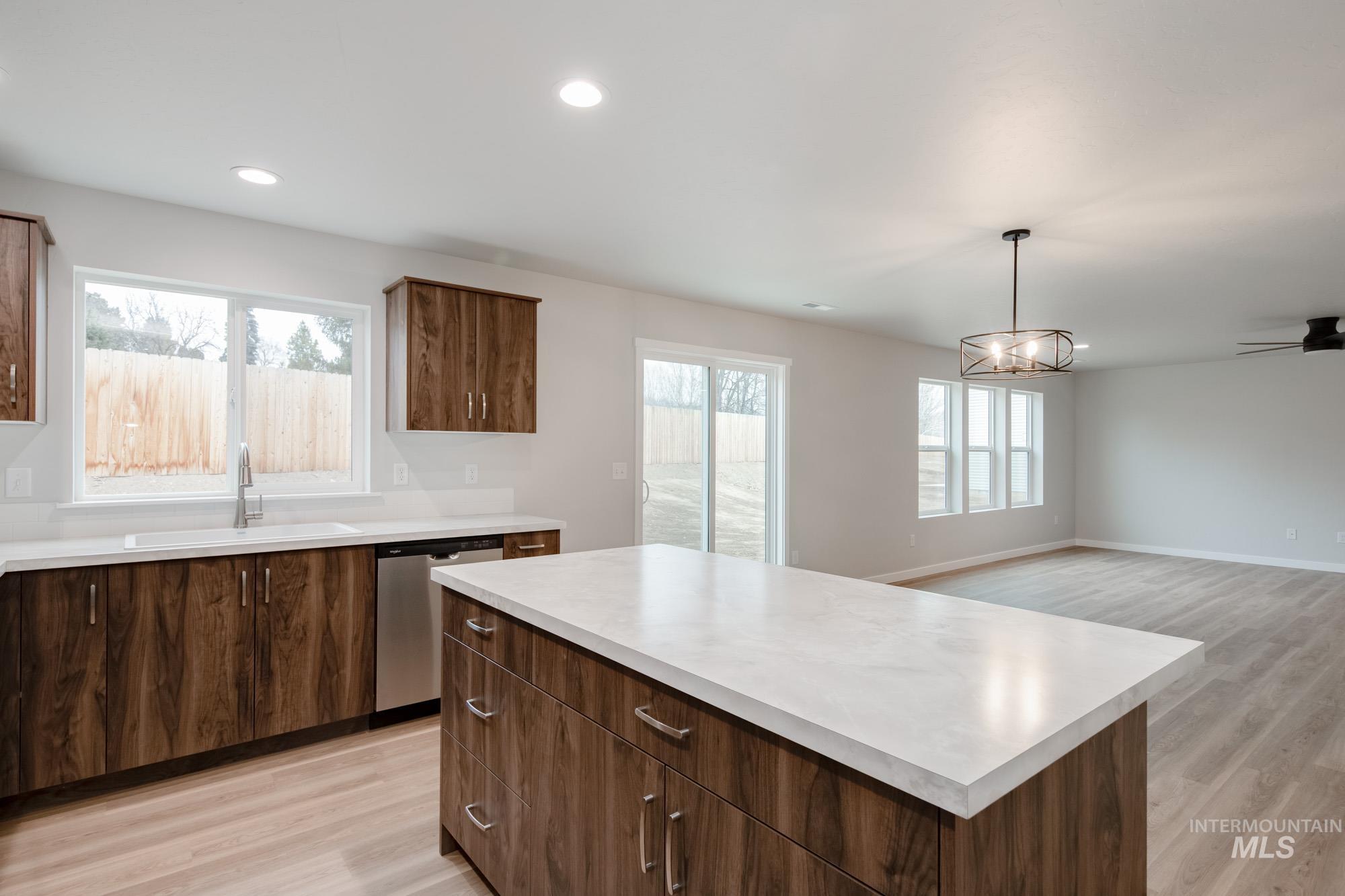1494 Long Pond Street Middleton, ID 83644 - Photo 7 of 24 Kitchen with light wood-type flooring, light countertops, a center island, plenty of natural light, and recessed lighting