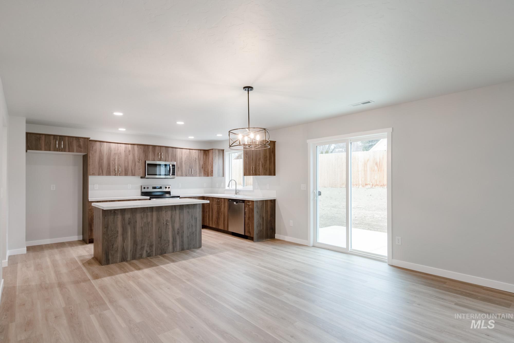 1494 Long Pond Street Middleton, ID 83644 - Photo 10 of 25 Kitchen with light countertops, a center island, decorative light fixtures, recessed lighting, and a chandelier