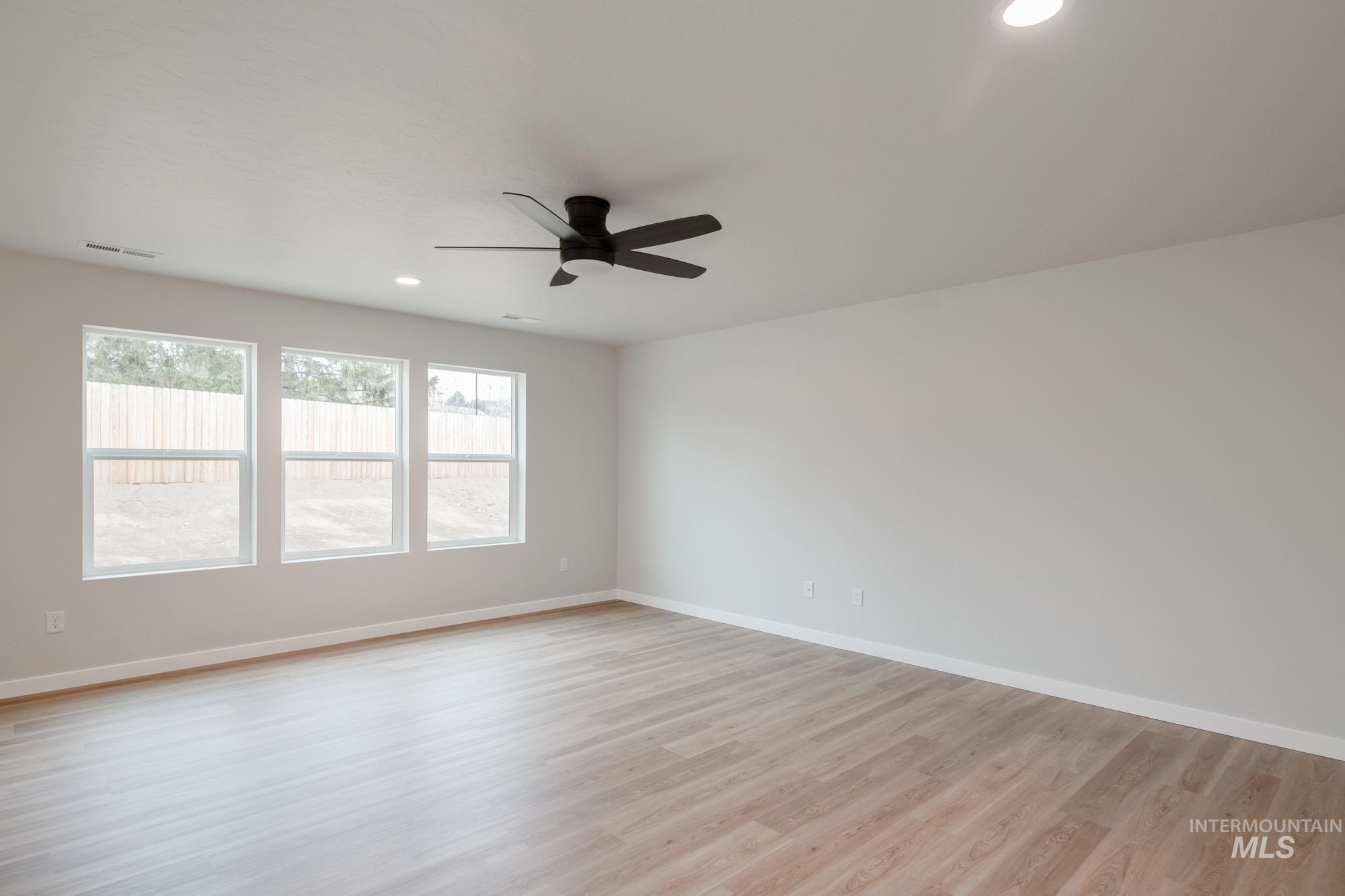 1494 Long Pond Street Middleton, ID 83644 - Photo 10 of 24 Spare room featuring recessed lighting, light wood-style floors, and a ceiling fan