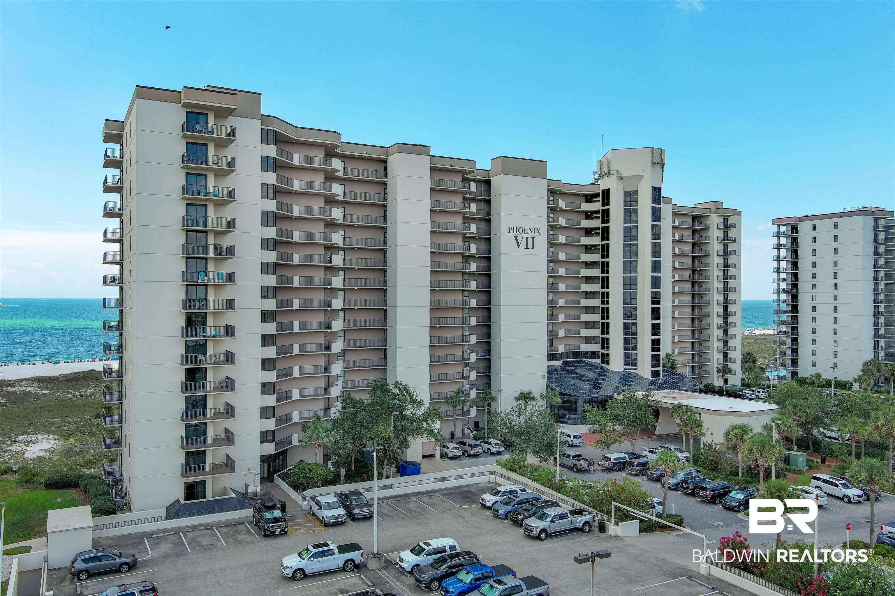 26802 Perdido Beach Boulevard, Unit 406 Orange Beach, AL 36561 - Photo 22 of 37 View of apartment building / complex featuring a water view and uncovered parking