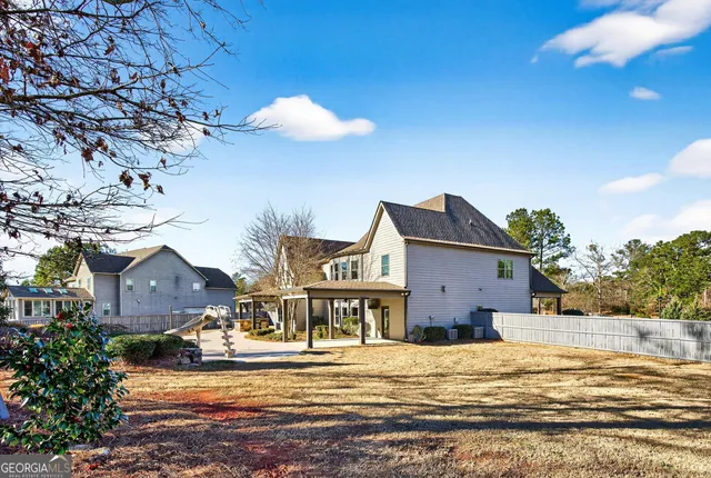 a kitchen with stainless steel appliances granite countertop a stove refrigerator and chairs