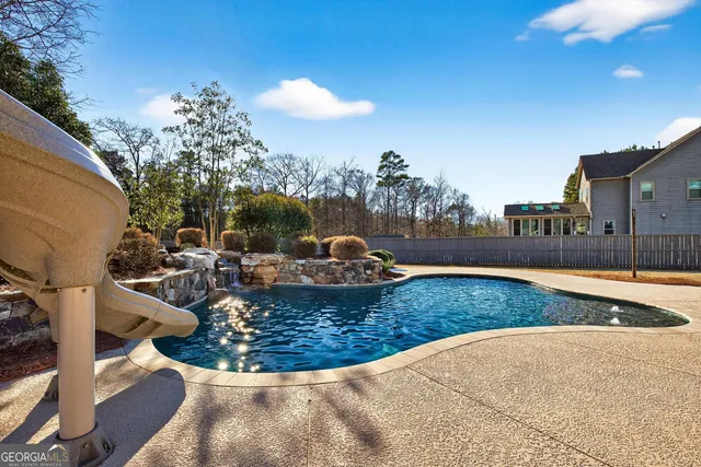 a kitchen with granite countertop white cabinets and a stove top oven