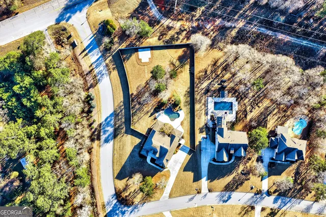 a kitchen with stainless steel appliances kitchen island granite countertop a table chairs and a wooden floor