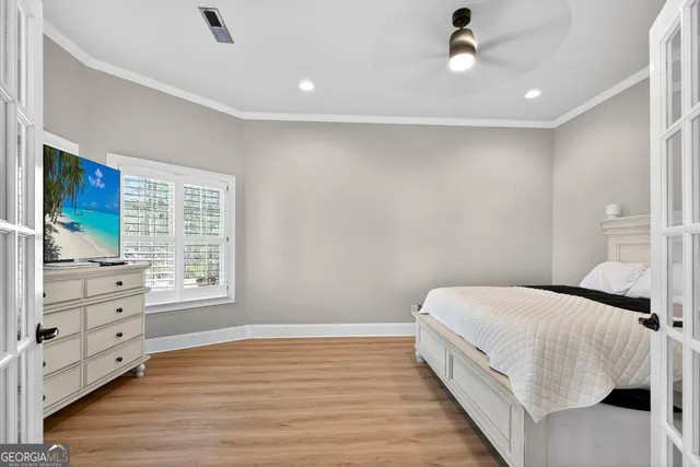 a spacious bedroom with a bed and a window