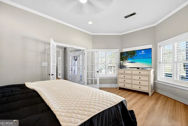 a bedroom with a bed and a ceiling fan