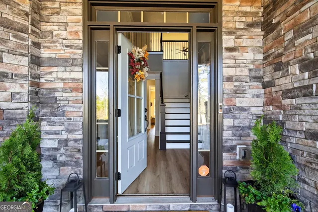 a view of a porch with a table and chairs and potted plants