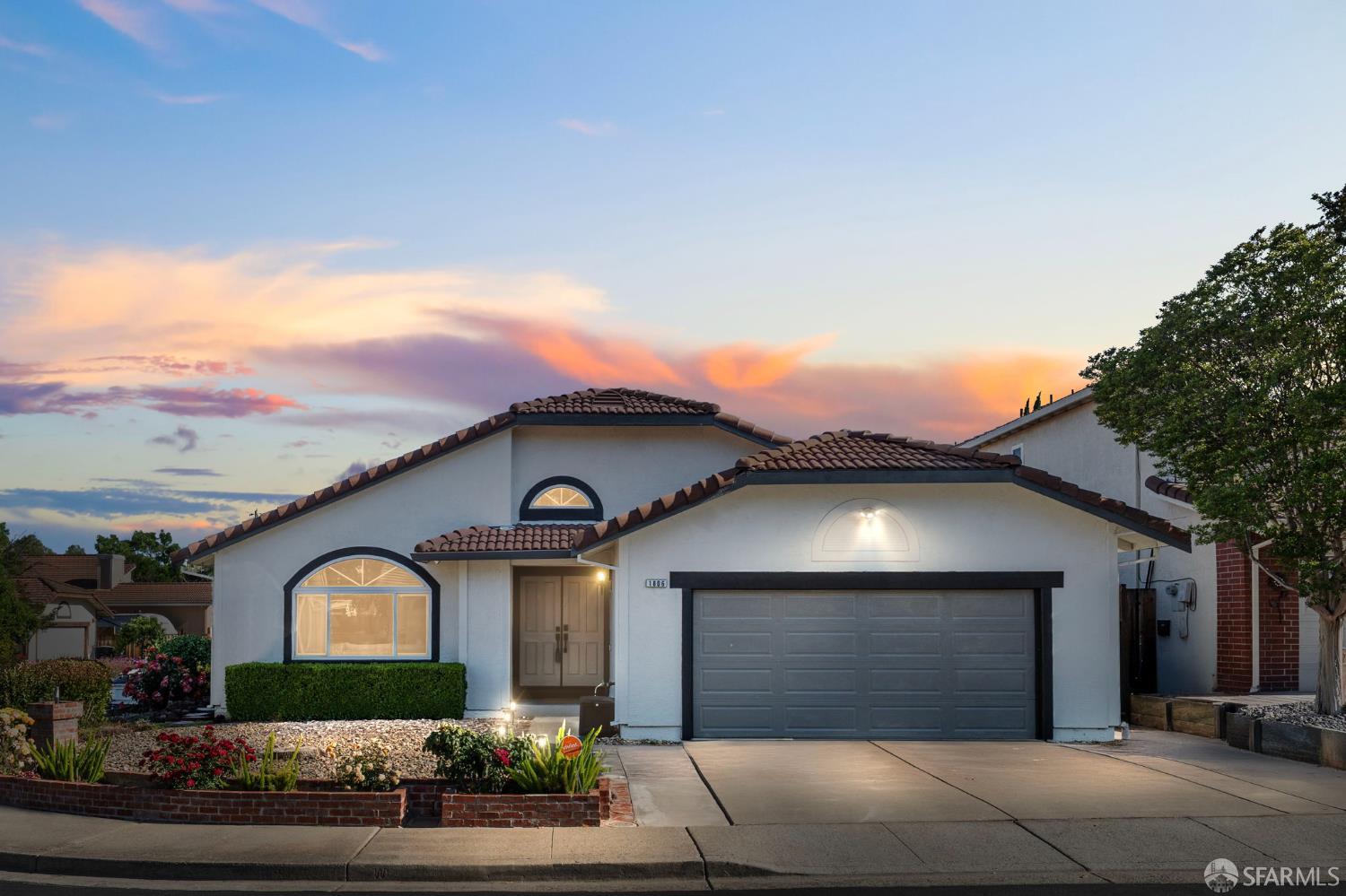 a front view of a house with garden