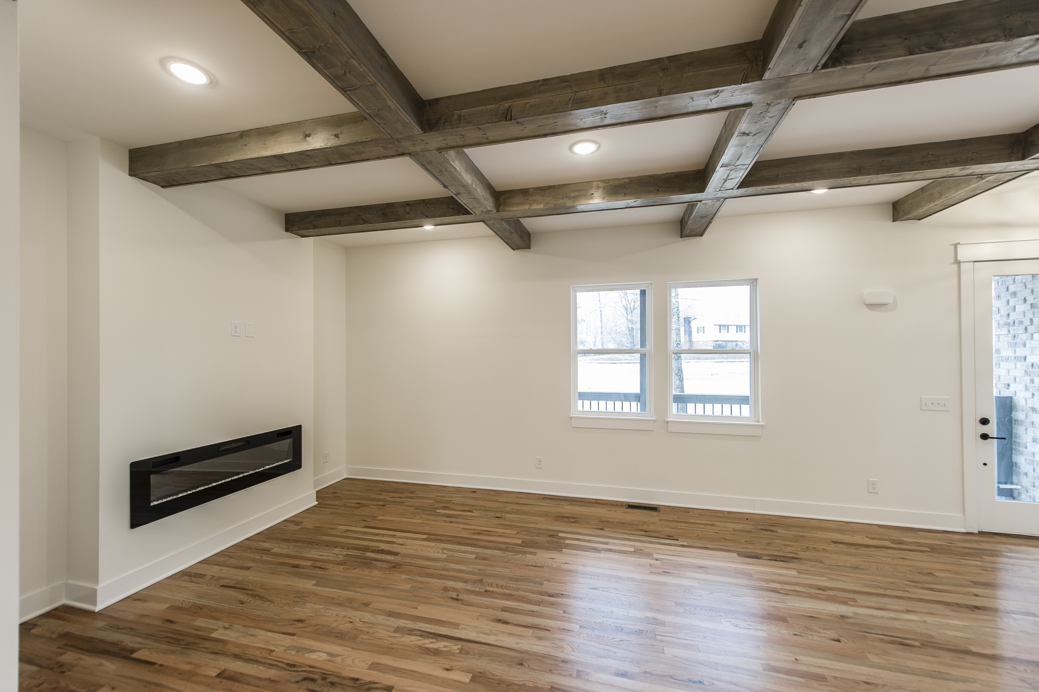 2026 Beaver Ridge Road Burns, TN 37029 - Photo 5 of 45 a view of an empty room with wooden floor and a window