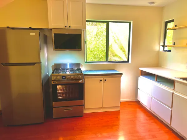 a kitchen with stainless steel appliances a refrigerator and a stove