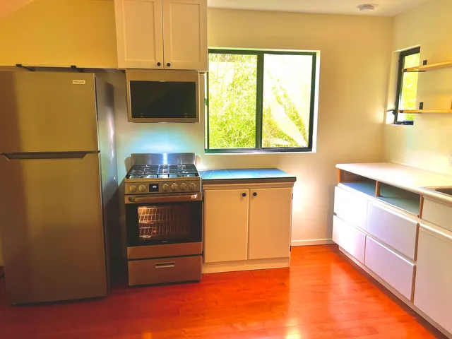 a kitchen with stainless steel appliances a refrigerator and a stove