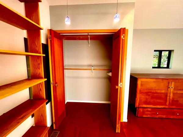 a view of walk in closet with empty racks