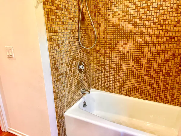 a utility room with a sink and a bed