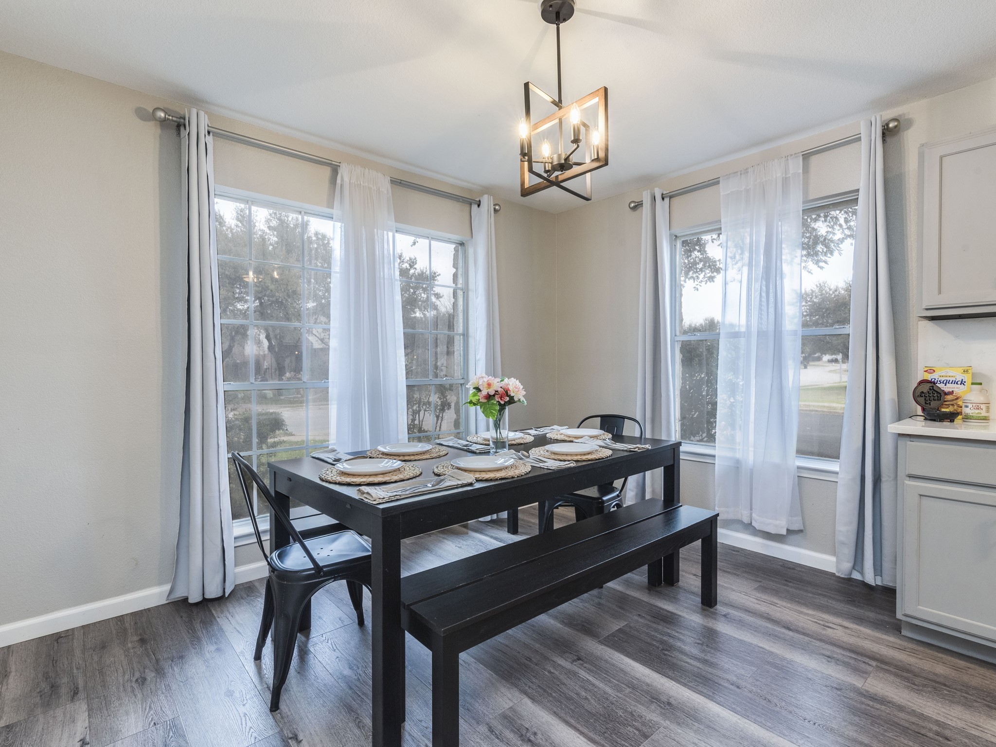 1415 Roxanne's Run Pflugerville, TX 78660 - Photo 15 of 30 A well-lit dining area featuring rich hardwood floors and an elegant light fixture.