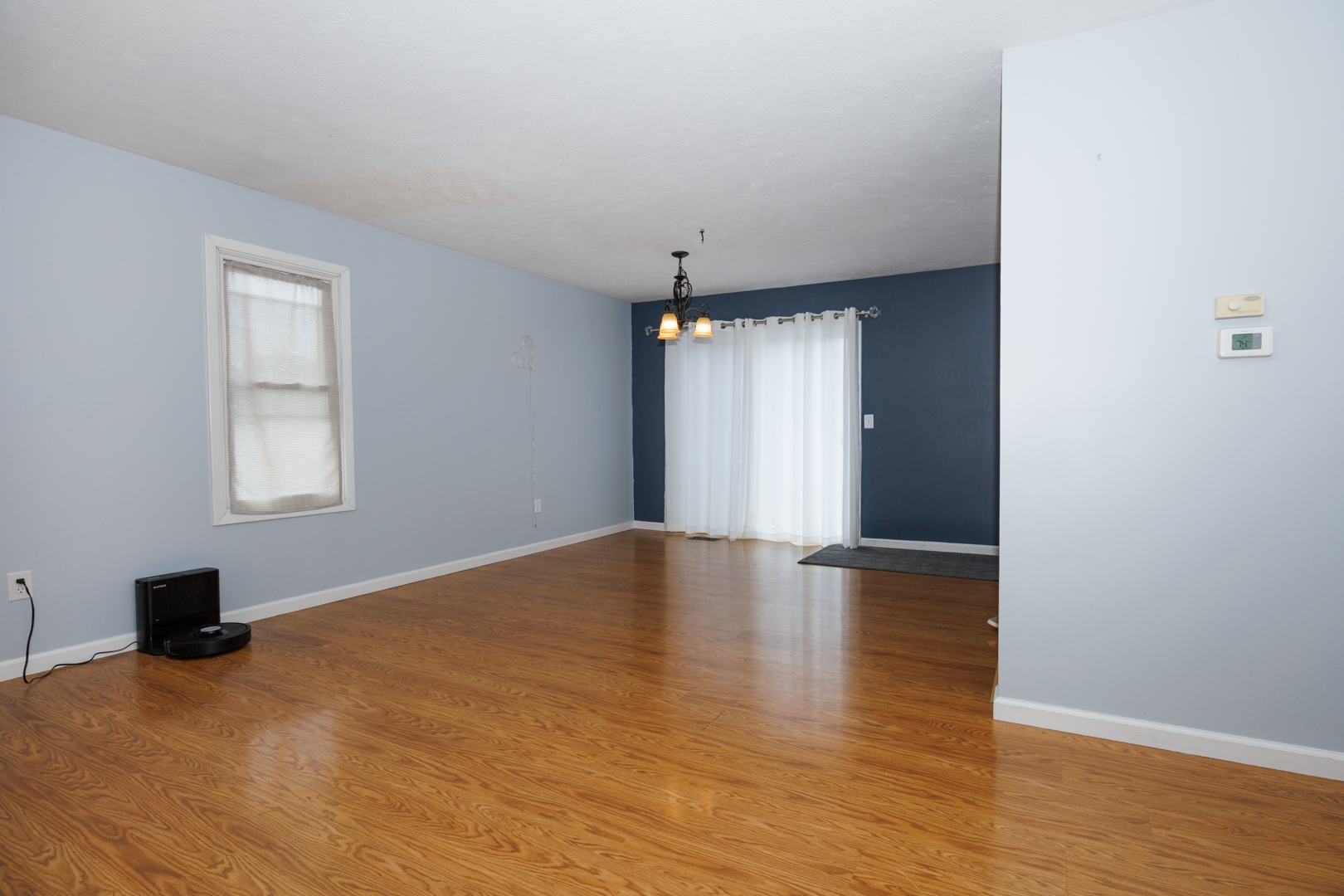 107 Regal Drive Normal, IL 61761 - Photo 4 of 41 a view of empty room with wooden floor and fan