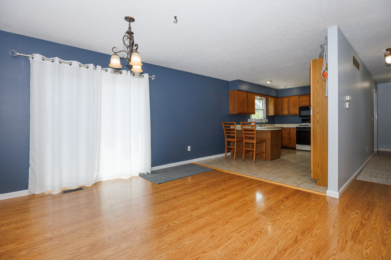 107 Regal Drive Normal, IL 61761 - Photo 7 of 41 a view of a kitchen with a dining table chairs and wooden floor