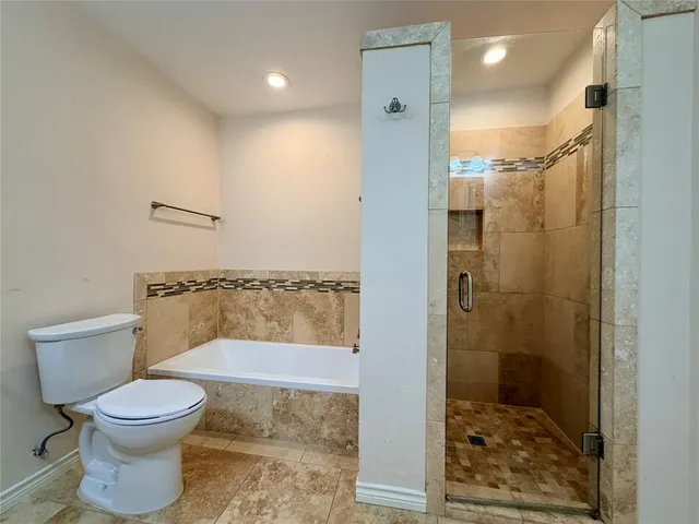a bathroom with a toilet and a shower