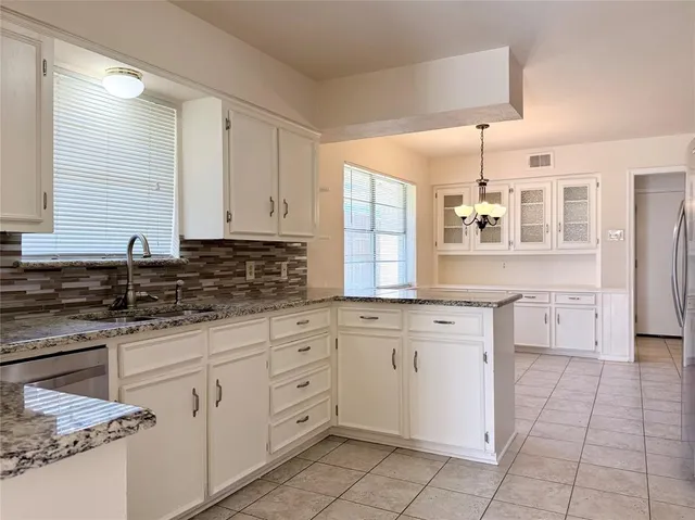 a kitchen with a sink stove and cabinets