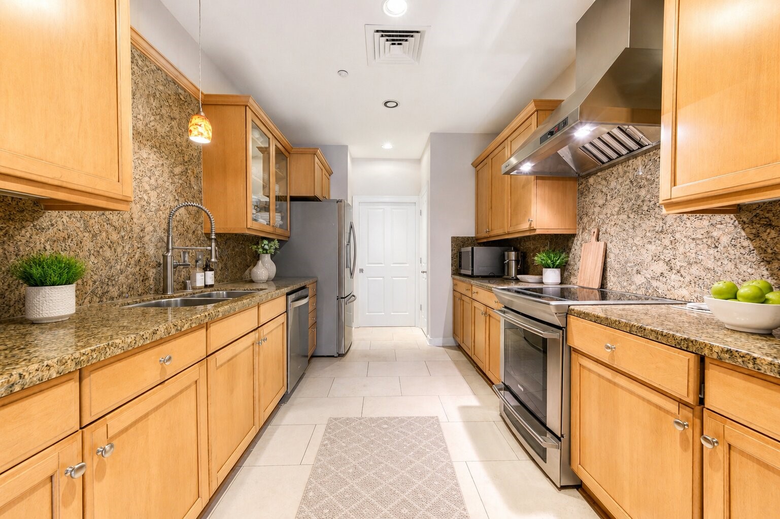 914 Main Street, Unit 911 Houston, TX 77002 - Photo 15 of 30 a large kitchen with stainless steel appliances granite countertop a sink a stove and cabinets