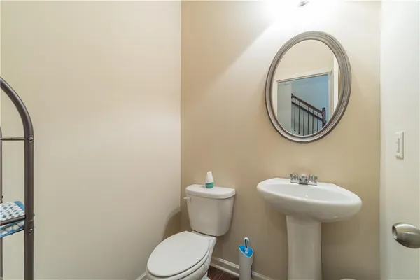 a bathroom with a toilet a sink and a mirror