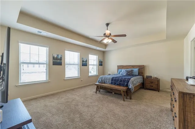 a living room with furniture and a ceiling fan