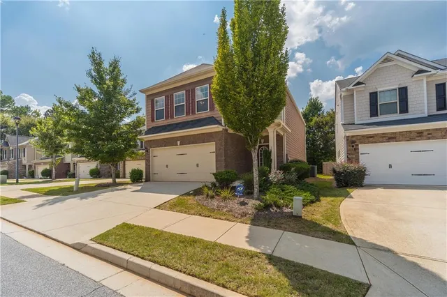 a front view of a house with garden
