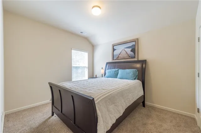 a bedroom with a bed and window