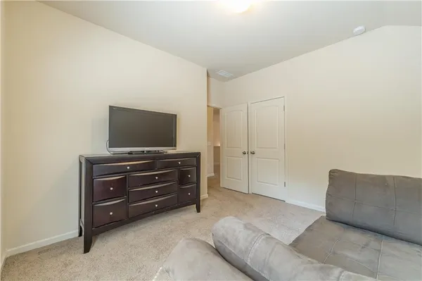 a living room with furniture and flat screen tv