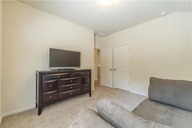 a living room with furniture and flat screen tv