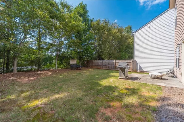 a view of a backyard with swimming pool