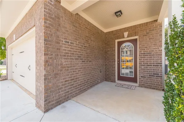 a view of front door with brick wall
