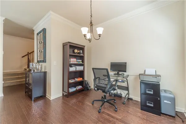 a view of a workspace with furniture and a window