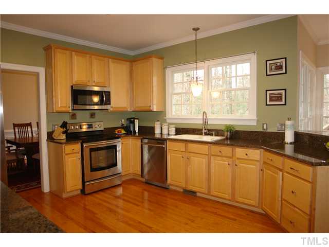 2808 Sunnystone Way Raleigh, NC 27613 - Photo 3 of 21 a kitchen with stainless steel appliances granite countertop a stove a sink and a microwave