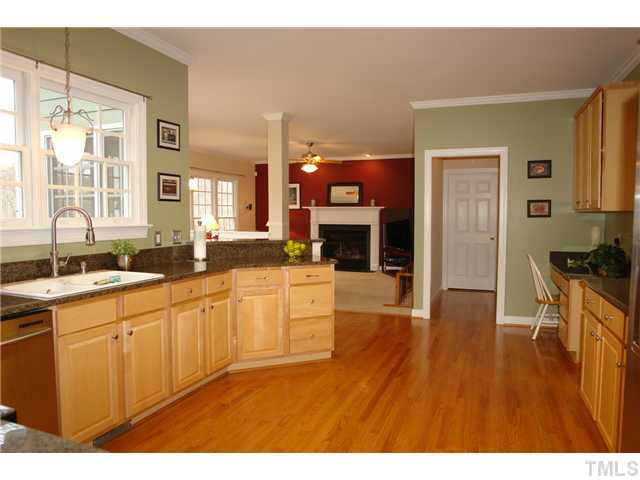 2808 Sunnystone Way Raleigh, NC 27613 - Photo 5 of 21 a open kitchen with stainless steel appliances granite countertop a sink dishwasher a stove and a refrigerator with wooden floor
