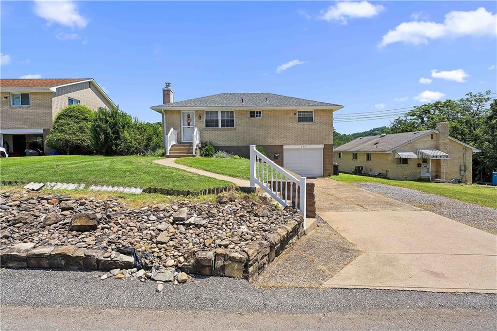 a front view of a house with a yard