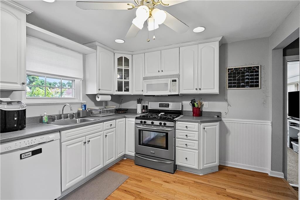 102 Adele Avenue Pittsburgh, PA 15223 - Photo 11 of 23 a kitchen with stainless steel appliances granite countertop a stove a sink and white cabinets