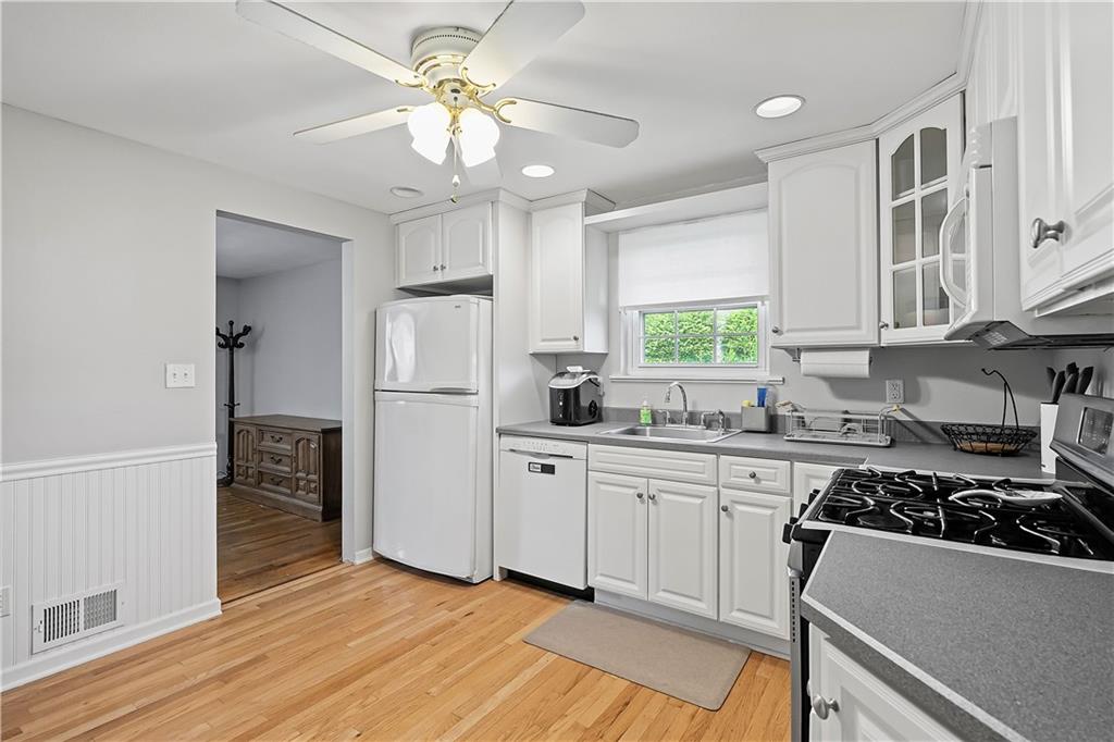 102 Adele Avenue Pittsburgh, PA 15223 - Photo 12 of 23 a kitchen with stainless steel appliances a sink a stove a refrigerator and cabinets