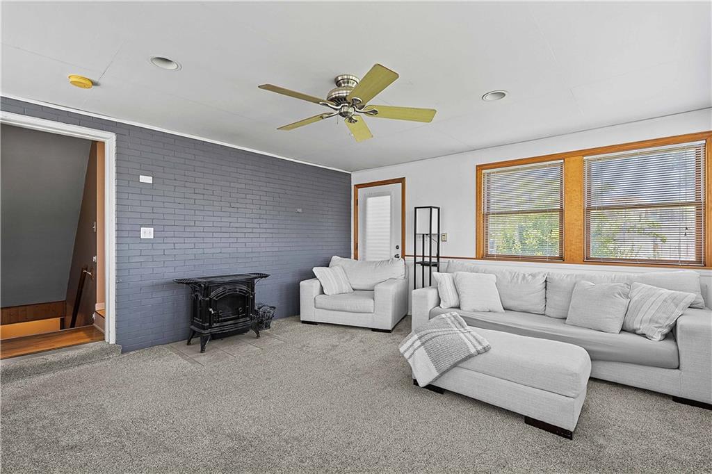 102 Adele Avenue Pittsburgh, PA 15223 - Photo 14 of 23 a living room with furniture and a fireplace