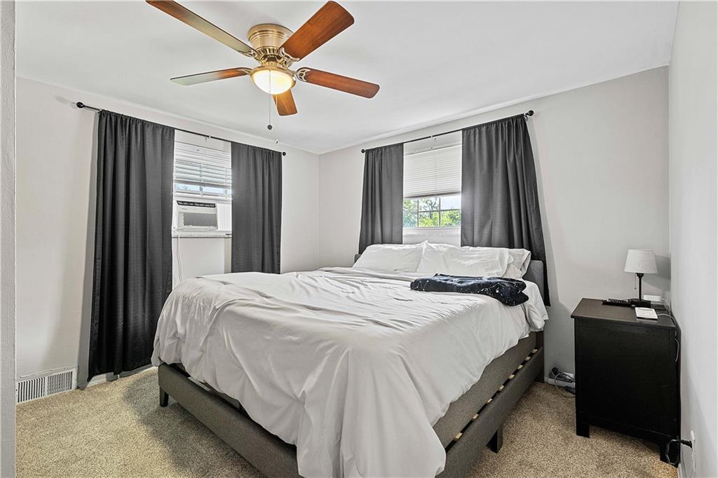 102 Adele Avenue Pittsburgh, PA 15223 - Photo 18 of 23 a bedroom with a bed and a chandelier