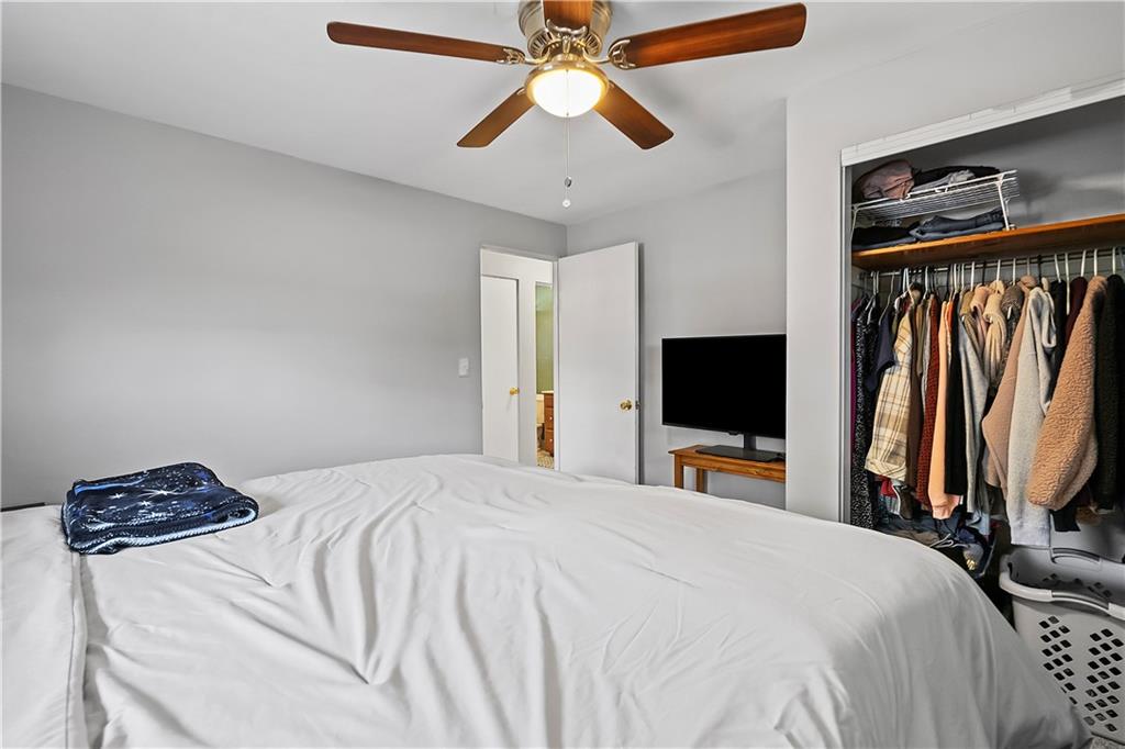 102 Adele Avenue Pittsburgh, PA 15223 - Photo 19 of 23 a bedroom with a bed and a flat tv screen on dresser