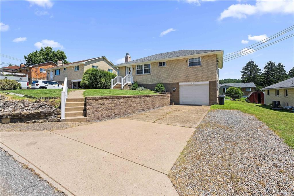 102 Adele Avenue Pittsburgh, PA 15223 - Photo 2 of 23 a front view of a house with a yard and garage