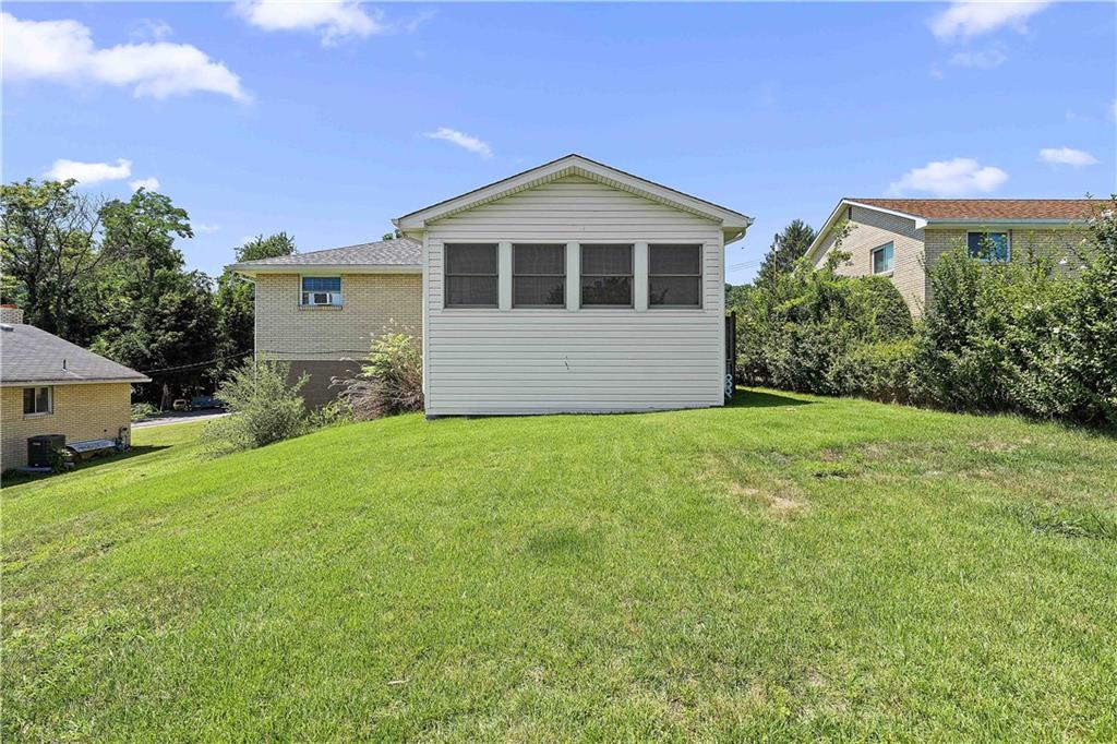 102 Adele Avenue Pittsburgh, PA 15223 - Photo 3 of 23 a front view of a house with a garden