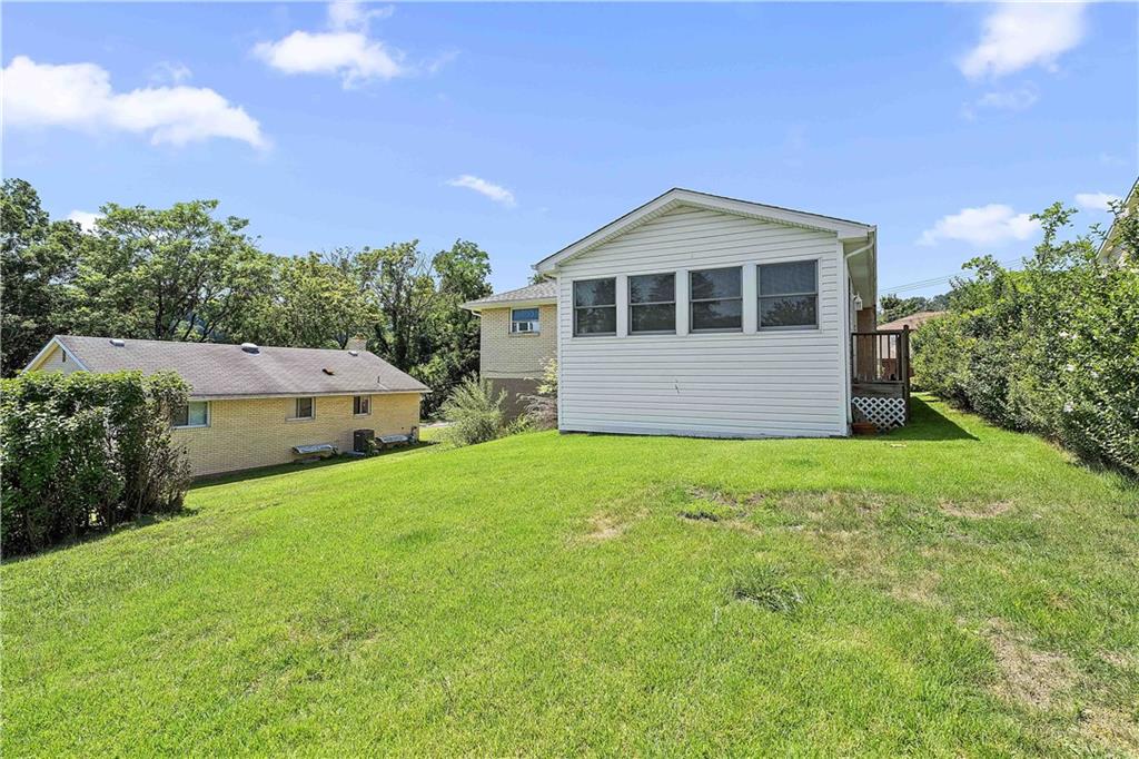 102 Adele Avenue Pittsburgh, PA 15223 - Photo 4 of 23 a front view of a house with a yard and garage