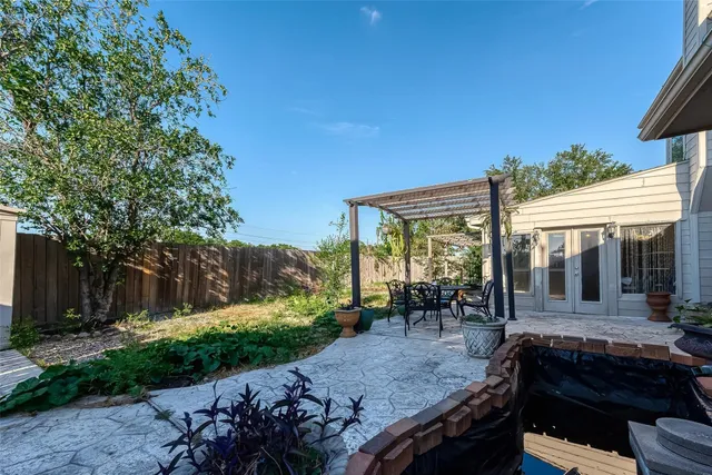 a view of a patio with table and chairs and potted plants