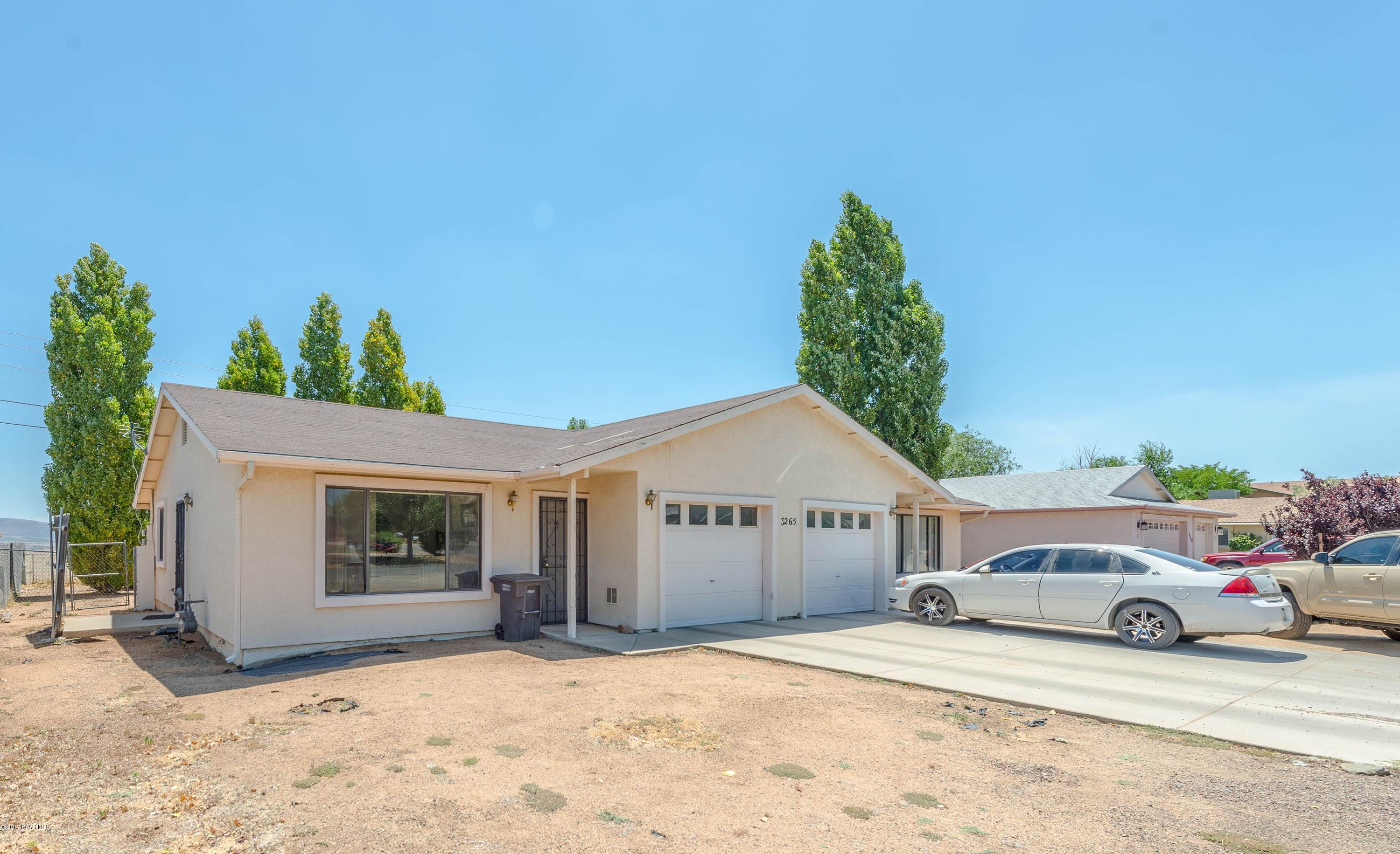 a car parked in front of white house