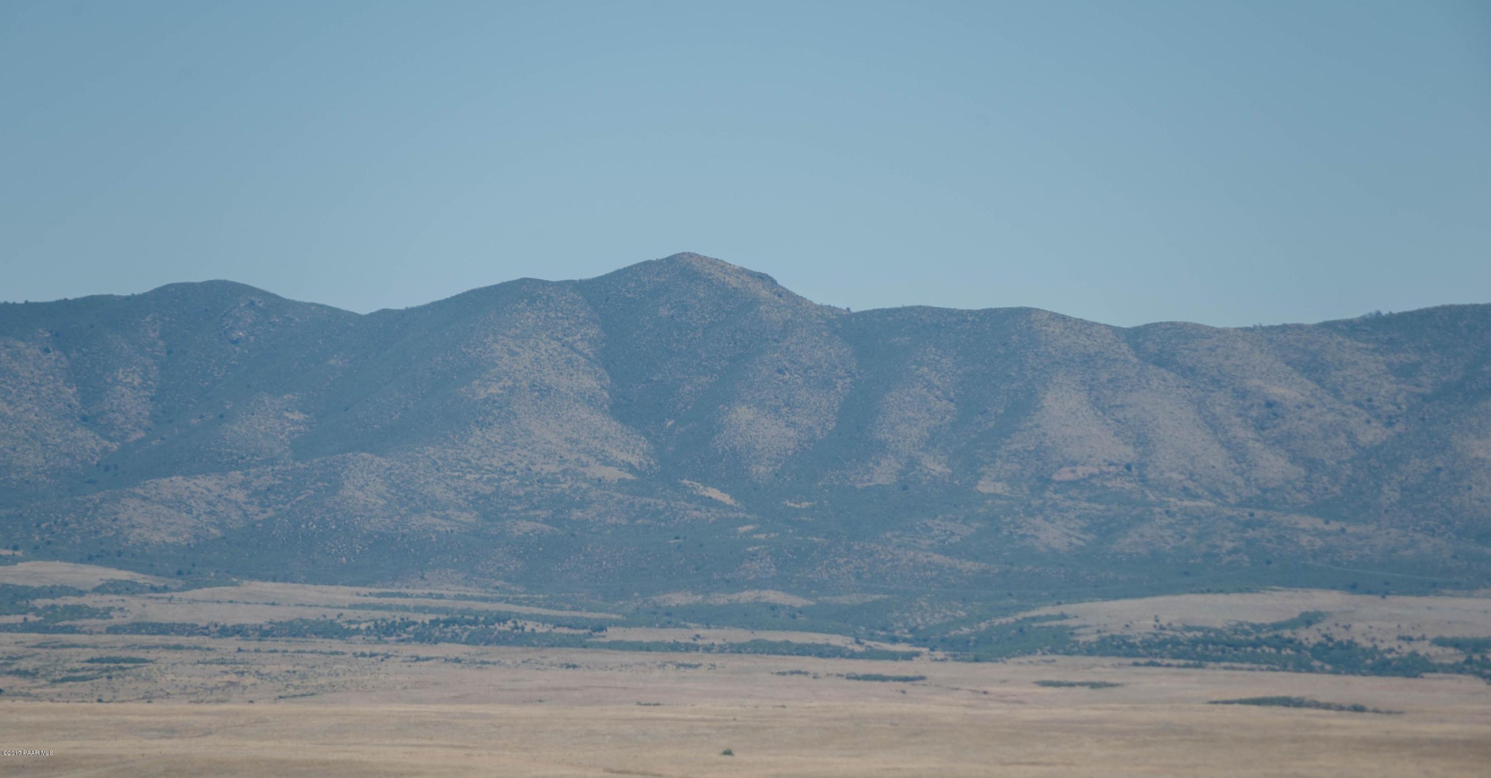 3265 North Yavapai Road East Prescott Valley, AZ 86314 - Photo 14 of 19 a view of a dry yard with mountains in the background