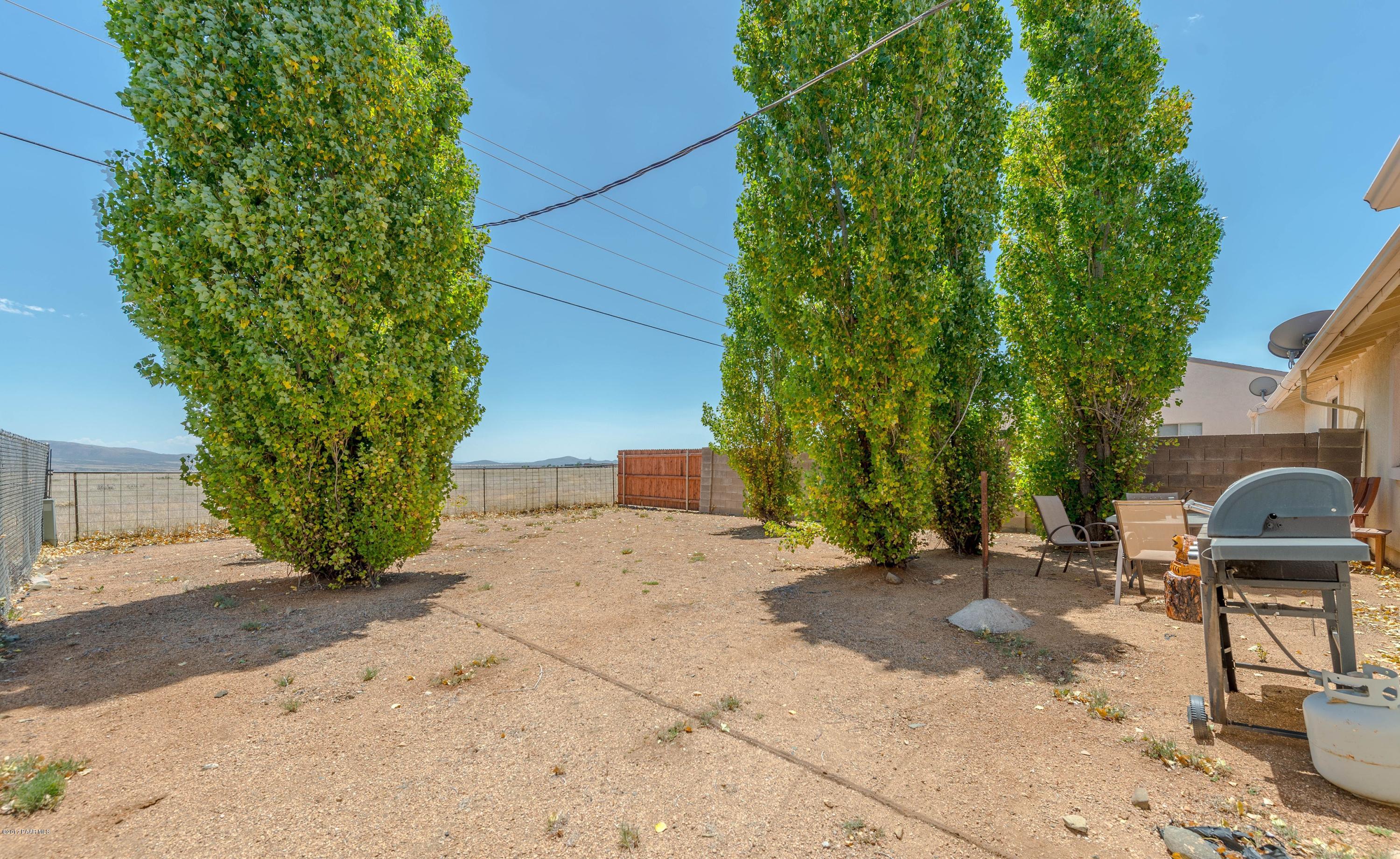 3265 North Yavapai Road East Prescott Valley, AZ 86314 - Photo 15 of 19 a view of a backyard with plants and trees