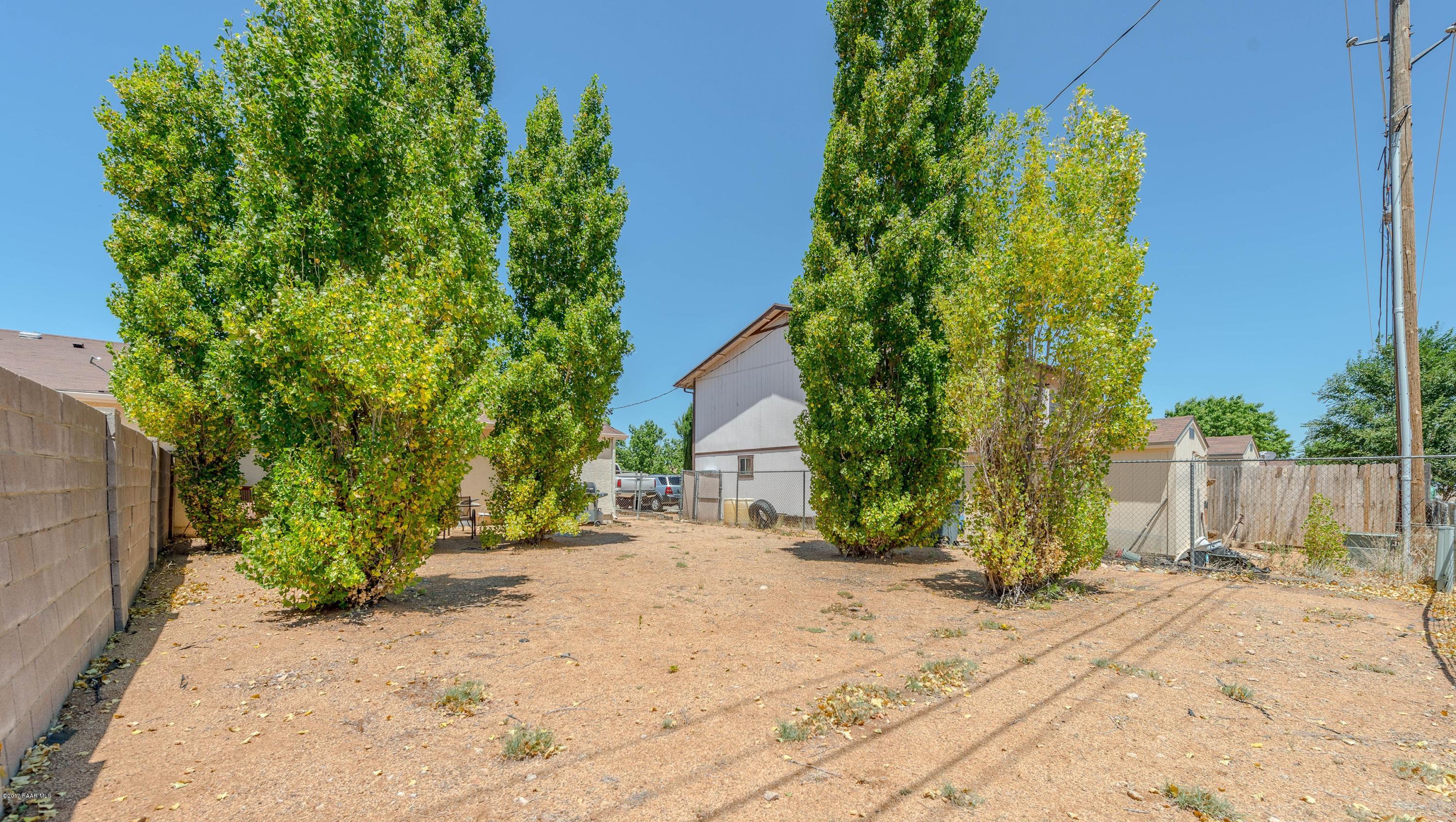 3265 North Yavapai Road East Prescott Valley, AZ 86314 - Photo 19 of 19 a backyard of a house with plants and trees